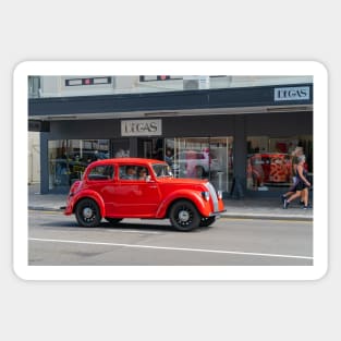 Red Morris 8 car in deco city of Napier New Zealand. Sticker